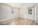 Spacious bedroom with hardwood floors, chandelier, and two windows at 3199 Mcafee Rd, Decatur, GA 30032