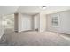 Spacious bedroom with gray carpet, double doors, and ensuite bathroom at 3199 Mcafee Rd, Decatur, GA 30032