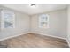 Well-lit bedroom featuring hardwood floors and two large windows at 3199 Mcafee Rd, Decatur, GA 30032
