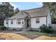 Front view of a charming white brick ranch house at 3199 Mcafee Rd, Decatur, GA 30032