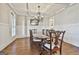 Elegant dining room featuring a large table, chandelier, and hardwood floors at 209 Gates Entry, Peachtree City, GA 30269