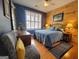 Bedroom with wood-paneled accent wall, queen-size bed, and window shutters at 511 Bonneset Ct, Canton, GA 30114