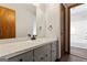 Bathroom with gray vanity, black faucet, and a view to the shower at 5427 Forest Pines Dr, Lithonia, GA 30058