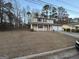 View of the front elevation showing a spacious lot, covered front porch and two-car garage at 5427 Forest Pines Dr, Lithonia, GA 30058