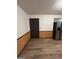 A corner of a kitchen with hardwood floors and a dark-stained door at 5427 Forest Pines Dr, Lithonia, GA 30058