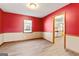 Living room with red walls leading to a bright, stainless steel kitchen at 5427 Forest Pines Dr, Lithonia, GA 30058