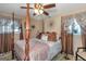 Spacious bedroom with a post bed, ceiling fan, and large windows at 100 Traverse Ct, College Park, GA 30349