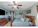 Main bedroom with a king bed, ceiling fan, and large TV at 100 Traverse Ct, College Park, GA 30349