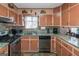 Kitchen with granite countertops, light brown cabinets, and stainless steel appliances at 100 Traverse Ct, Atlanta, GA 30349