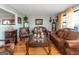 Living room with hardwood floors, brown leather couches, and decorative accents at 100 Traverse Ct, Atlanta, GA 30349