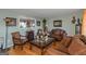 Living room with hardwood floors, brown leather couches, and decorative accents at 100 Traverse Ct, College Park, GA 30349