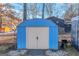 Blue storage shed with double doors at 100 Traverse Ct, Atlanta, GA 30349