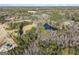 Aerial view of property with a pond and surrounding trees at 255 Barnett Road Rd, Hampton, GA 30228