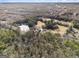 Aerial view of property with a pond and surrounding woodland at 255 Barnett Road Rd, Hampton, GA 30228