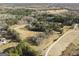 Aerial view of wooded property with driveway and small pond at 255 Barnett Road Rd, Hampton, GA 30228