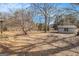 View of backyard with storage shed and waterfront at 255 Barnett Road Rd, Hampton, GA 30228