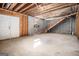 Unfinished basement with block walls, exposed ceiling, stairs, and an exterior door at 255 Barnett Road Rd, Hampton, GA 30228