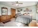 Comfortable bedroom featuring floral wallpaper border, a ceiling fan, wood furnishings, and natural light at 255 Barnett Road Rd, Hampton, GA 30228