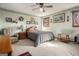 Cozy bedroom featuring a queen bed, accent chair, floral wallpaper border, and natural light from two windows at 255 Barnett Road Rd, Hampton, GA 30228