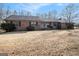 Brick single story home with mature trees and established landscaping at 255 Barnett Road Rd, Hampton, GA 30228