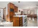 The kitchen features ample wooden cabinetry, a white cooktop island, and a view into the dining area at 255 Barnett Road Rd, Hampton, GA 30228