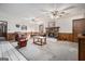 Carpeted living room with brick fireplace and ceiling fans at 255 Barnett Road Rd, Hampton, GA 30228