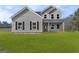 Charming two-story home with gray siding, black shutters and a well-manicured green lawn at 107 Oak Road, Locust Grove, GA 30248