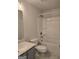 Bathroom featuring a toilet, vanity with gray cabinets, and shower/tub combo at 1455 Weeping Tree Cir, Auburn, GA 30011