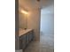 Bathroom features a vanity with a single sink, modern fixtures, and tiled flooring at 1455 Weeping Tree Cir, Auburn, GA 30011