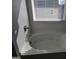 Bright bathtub beneath a window with blinds creating shadows at 1455 Weeping Tree Cir, Auburn, GA 30011