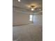 Bedroom featuring neutral carpet, a ceiling fan, a large window and white molding at 1455 Weeping Tree Cir, Auburn, GA 30011