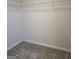 Empty carpeted walk-in closet with wire shelving and white walls at 1455 Weeping Tree Cir, Auburn, GA 30011