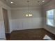 An empty dining room with board and batten walls, hardwood flooring, and modern light fixture at 1455 Weeping Tree Cir, Auburn, GA 30011