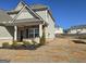 Two-story home with gray siding, stone accents, and manicured front yard at 1455 Weeping Tree Cir, Auburn, GA 30011