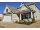 Two-story home with gray siding, stone accents, and manicured front yard at 1455 Weeping Tree Cir, Auburn, GA 30011
