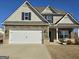 Inviting exterior showing stone detailing, well-kept lawn, and a bright, modern front facade at 1455 Weeping Tree Cir, Auburn, GA 30011
