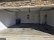 An empty, attached two car garage featuring stone accent wall at 1455 Weeping Tree Cir, Auburn, GA 30011