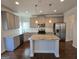 Bright kitchen with granite countertops, stainless steel appliances, and a spacious center island at 1455 Weeping Tree Cir, Auburn, GA 30011