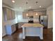 Open kitchen with stainless steel appliances, granite countertops, and a convenient center island at 1455 Weeping Tree Cir, Auburn, GA 30011