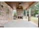 Covered patio with brick fireplace and ceiling fan at 870 N Bethany Rd, Mcdonough, GA 30252