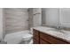 Bathroom with granite countertop and tiled shower at 870 N Bethany Rd, Mcdonough, GA 30252