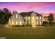 Two-story brick home with a welcoming front porch and landscaped lawn at 870 N Bethany Rd, Mcdonough, GA 30252