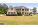 Two-story brick home with a large front yard and mature trees at 870 N Bethany Rd, Mcdonough, GA 30252