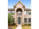 Two-story brick home with arched entryway and gray door at 870 N Bethany Rd, Mcdonough, GA 30252