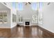 Spacious great room featuring hardwood floors, a fireplace, and large windows at 870 N Bethany Rd, Mcdonough, GA 30252
