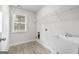 Bright laundry room with utility sink and overhead shelving at 870 N Bethany Rd, Mcdonough, GA 30252