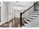 Modern staircase with dark wood and metal railing at 870 N Bethany Rd, Mcdonough, GA 30252