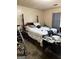 Bedroom with dark wood bed frame and white patterned bedspread at 241 E Ash St, Social Circle, GA 30025