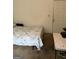 Small bedroom with a bed and stained walls adjacent to a door at 241 E Ash St, Social Circle, GA 30025
