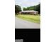 A single-story brick home with a lawn and a covered front porch at 241 E Ash St, Social Circle, GA 30025